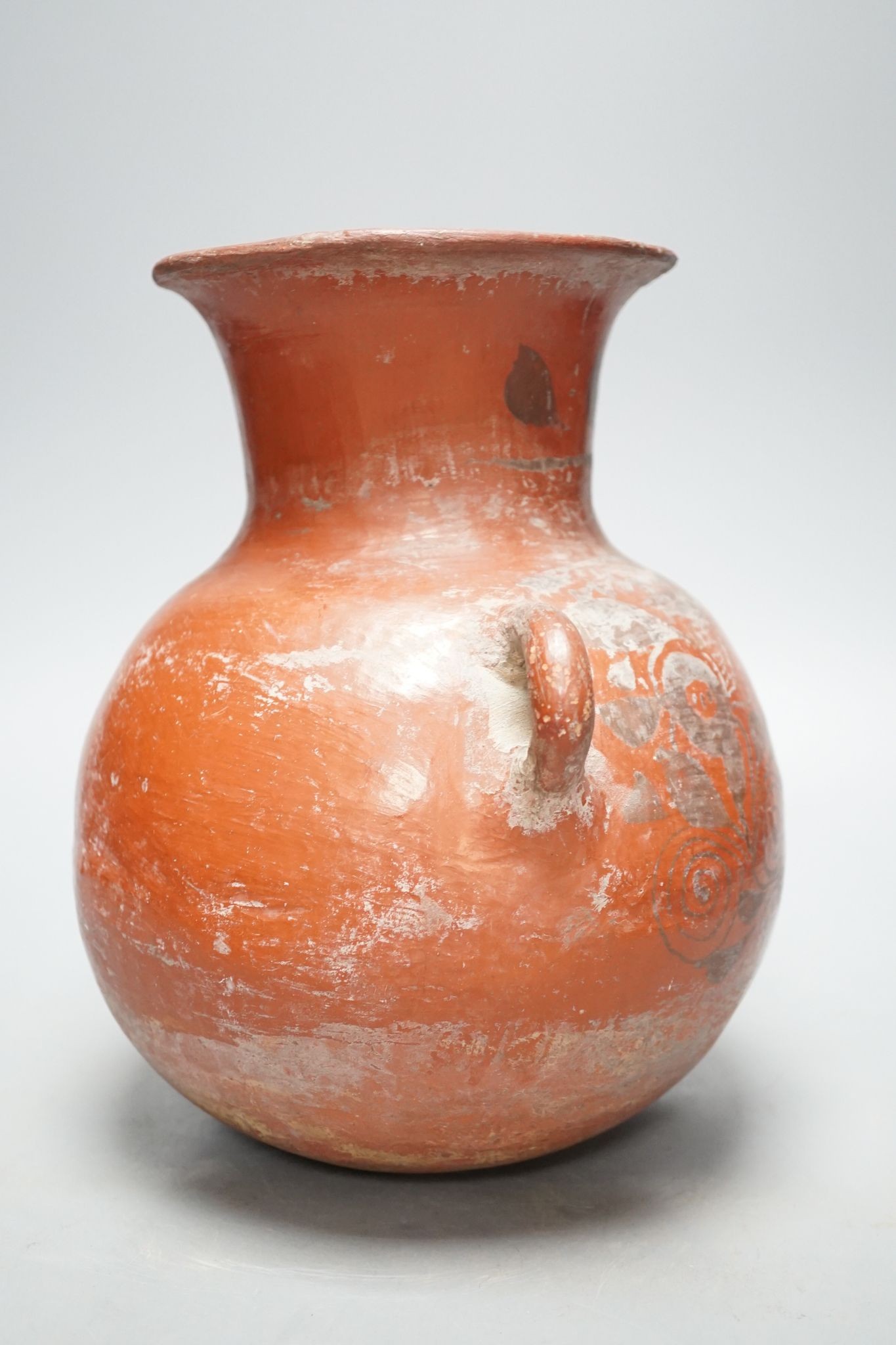 A pre-Columbian black and red pigment decorated two handled pot 25cm